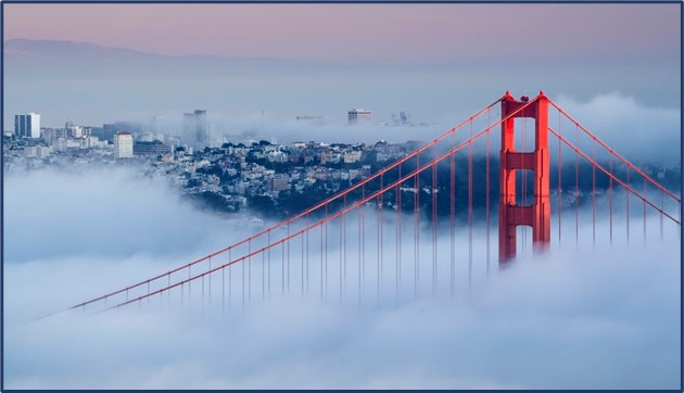 golden gate bridge partially covered by fog