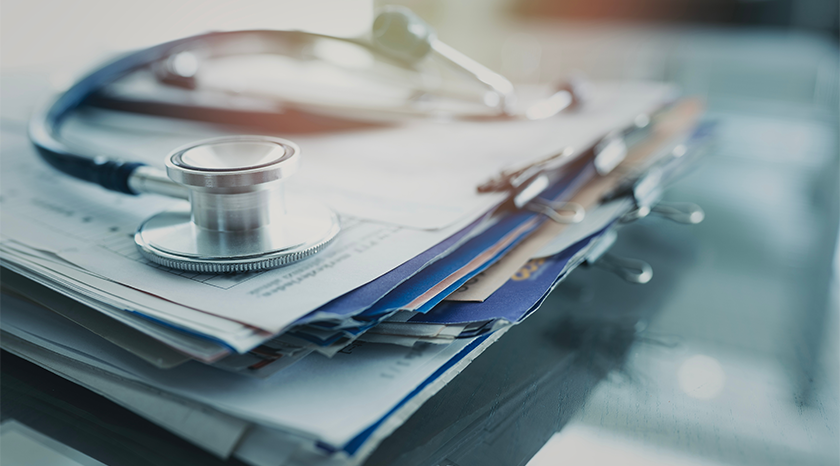 stethoscope placed on top of medical records